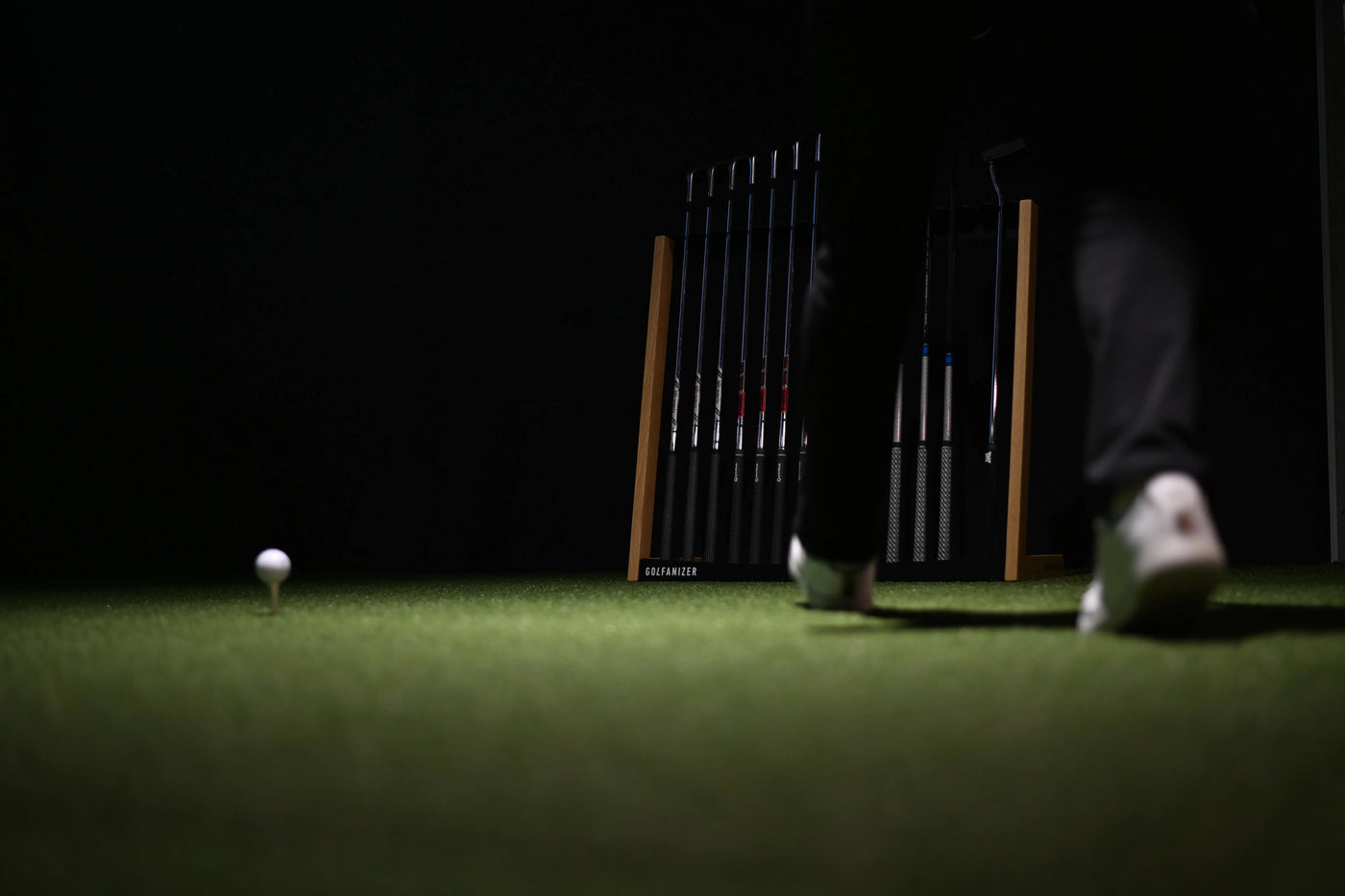 Golf Schlägerregal aus Eiche schwarz mit Golfschlägern, Golfer auf Kunstrasen, Golfball auf Tee