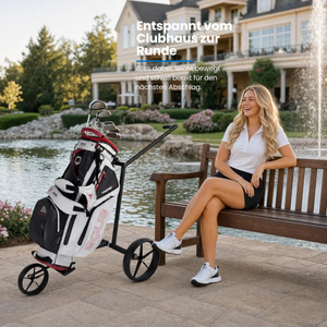 Big Max e-Lite 3 Rad Elektro Trolley mit Golftasche und Golferin am Teich im Hintergrund.